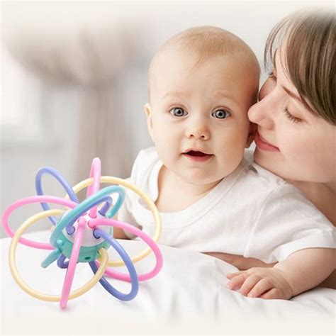 A Woman Is Kissing A Baby With An Object In Her Hand That Looks Like A Star