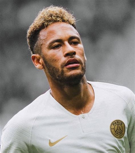 A Close Up Of A Soccer Player Wearing A White Uniform And Looking Off