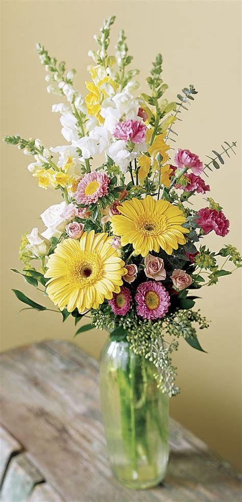 A Vase Filled With Lots Of Different Colored Flowers