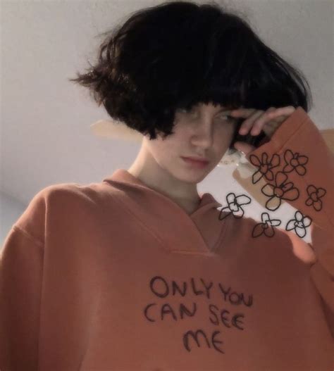 A Woman With Black Hair Wearing An Orange Sweatshirt That Says Only You