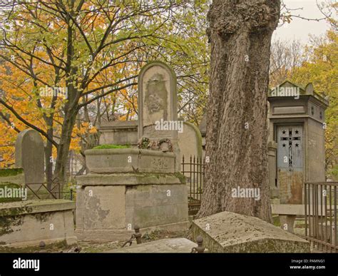 Old Grave Monuments And Trees Of Montmartre Cemetery Paris France