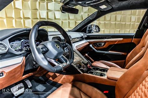 The Interior Of A Car With Brown Leather Trims And Steering Wheel