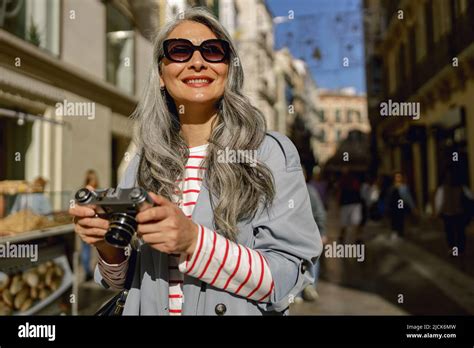 Busy Mature Lady Taking Stroll Through City Stock Photo Alamy