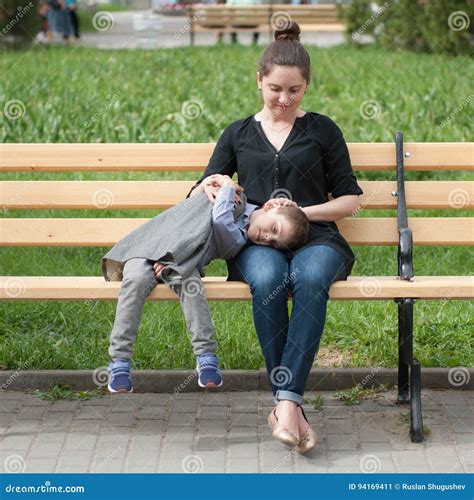 Little Boy Lies on His Mother`s Lap Sitting on the Bench Stock Image - Image of hand, love: 94169411