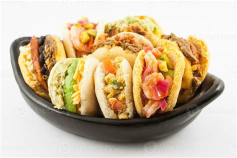 Arepas With Assorted Fillings Served In A Black Ceramic Dish On White Background 23619686 Stock