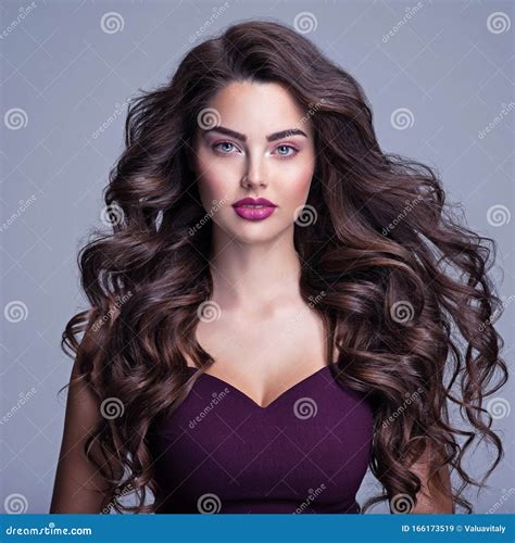 Face Of A Beautiful Woman With Long Brown Curly Hair Fashion Model With Wavy Hairstyle