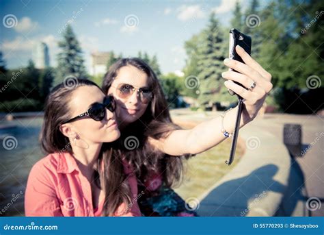 Two Young Women Taking A Selfie Outdoors Stock Image Image Of Cute