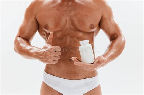 Man Bodybuilder Boxer With Naked Torso With Abs Holding A Can Of Muscle Growth Pills Steroids
