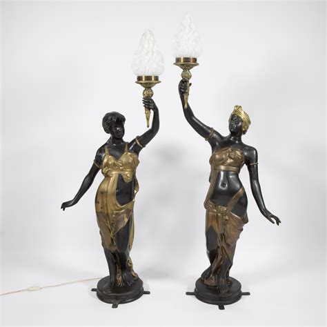 Lot - 2 imposing statues in bronze and gilt bronze of Venetian ladies, each carrying a torch as ...