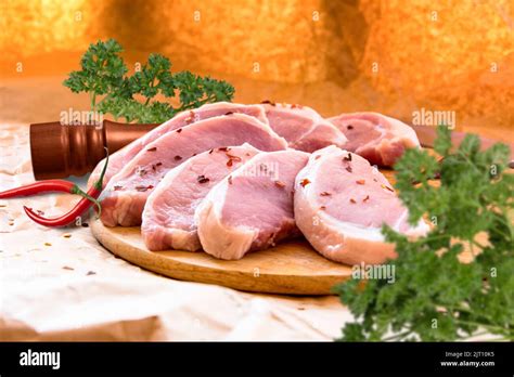 Fresh Raw Pork Chops On A Cutting Board Arrangement On The Wrapping