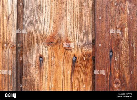 Holzwand aus alten Brettern mit Knoten und rostigen Nägeln natürlicher