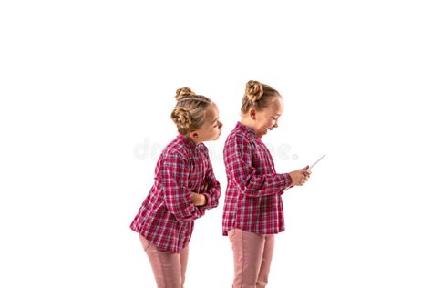 Young Handsome Girl Arguing With Herself On White Studio Background