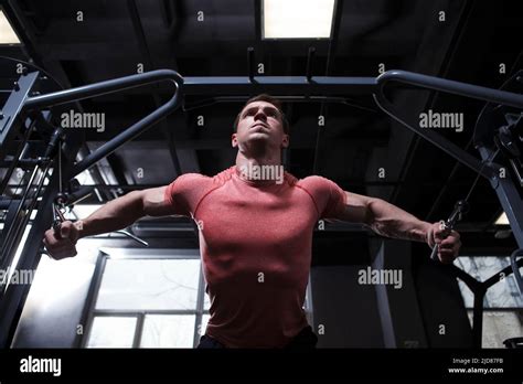 Low Angle Shot Of A Muscular Bodybuilder Working Out In Cable Crossover