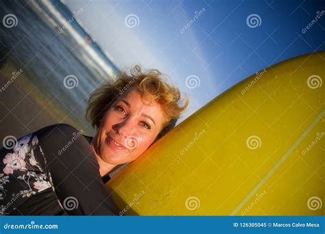 Lifestyle Portrait Of Young Beautiful And Happy Surfer Woman Holding