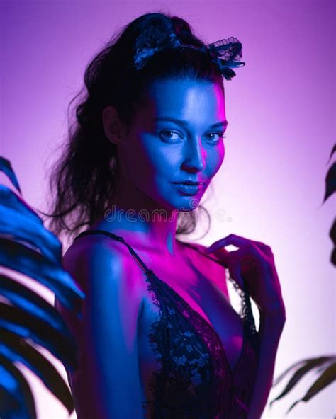 Seductive Woman In Lingerie Posing In Neon Lights With Tropical Leaves Stock Image Image Of