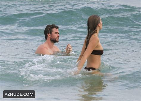 Hemsworth Shows Off His Ripped Beach Bod During A Morning Swim With Bikini Clad Girlfriend