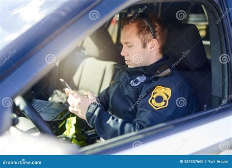 Communication Is Key For Safety A Handsome Young Male Police Officer