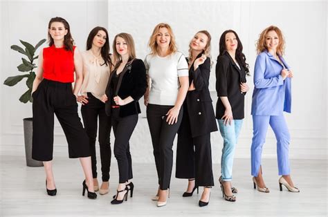 Premium Photo | A group of women dressed in business style are standing ...