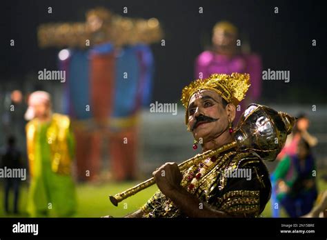 A Man Dressed As Demon King Ravana Waits For His Turn To Perform During