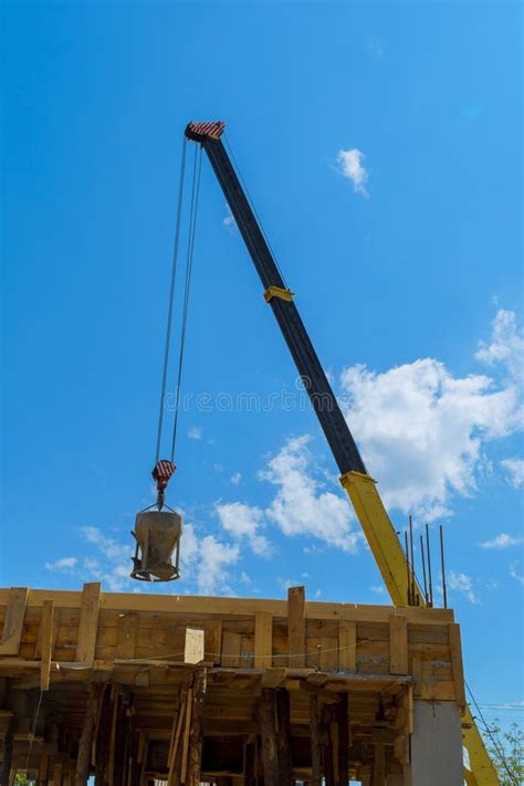 An Aerial Crane Lifts Concrete Bucket For Pouring Concrete Cement Mix