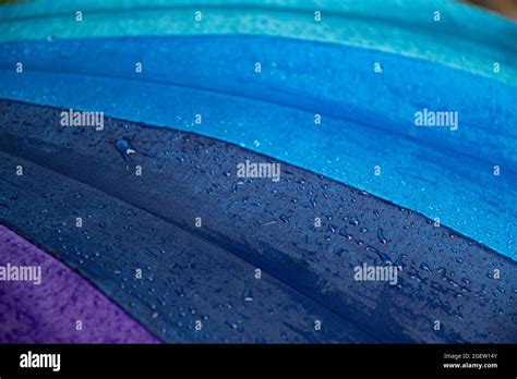 Wet Waterproof Textile Surface Of Blue Gradient Colored Umbrella Under