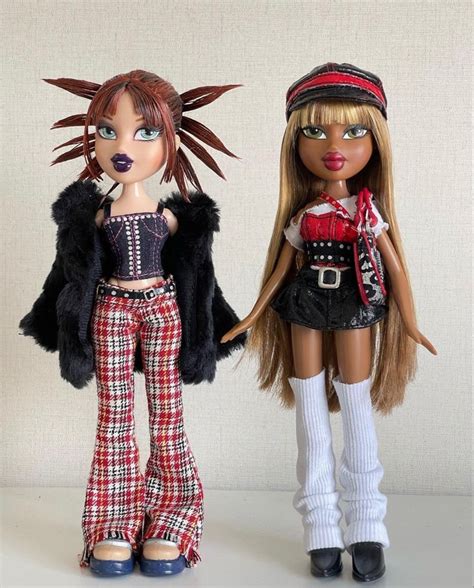 Two Dolls Are Standing Next To Each Other