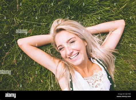 Happy Gorgeous Blonde Lying On Lawn Stock Photo Alamy