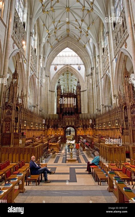 Two people sitting inside York Minster cathedral York UK Stock Photo ...