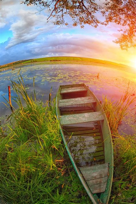 A Picturesque Landscape With A Boat In Reeds On The Lake On Suns Stock