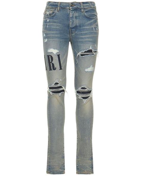 Amiri Logo Appliqué Stretch Denim Jeans in Clay Indigo Blue for Men