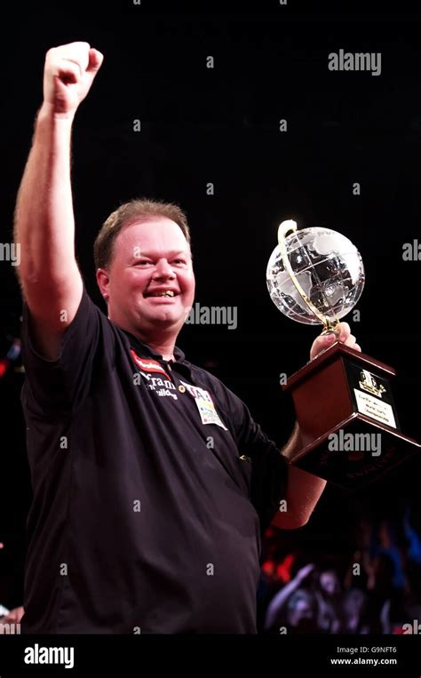 Netherlands Raymond Van Barneveld Celebrates With The Trophy Following