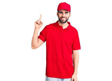 Premium Photo Young Handsome Man With Beard Wearing Delivery Uniform