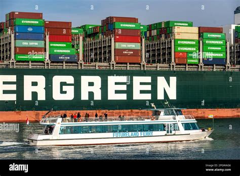 Harbour Tugs Bring The Container Freighter Ever Globe To Its Berth At