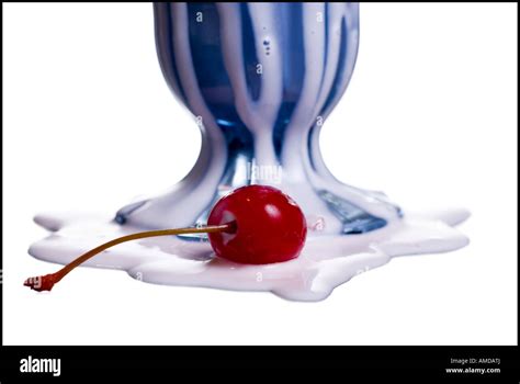 Close Up Of Base Of Melted Milkshake With Maraschino Cherry Stock Photo