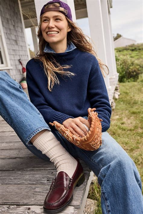 A Woman Sitting On The Porch With A Catchers Mitt