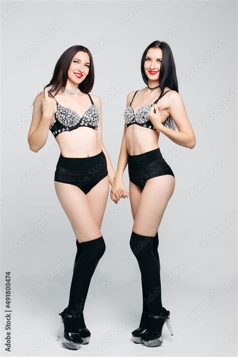 Seductive Twins In Shine And Glamorous Lingerie Posing With Crossed Hands Stock Photo Adobe Stock