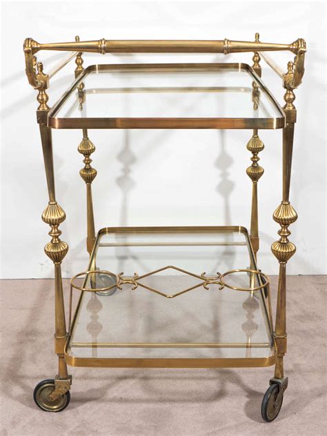 A Midcentury Hollywood Regency Brass Bar Cart With Wine Holders At