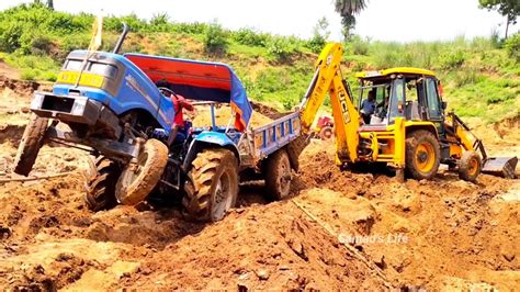 Jcb Dx Backhoe Loader Machine Loading Mud In Sonalika Di Rx Tractor