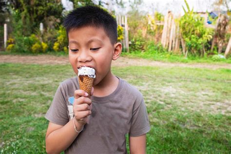 Boy eating an ice cream outside 1852455 Stock Photo at Vecteezy