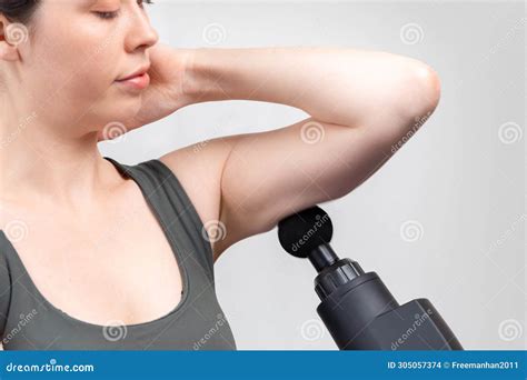 Close Up Of Caucasian Woman Gives Herself Massage On Upper Arm With