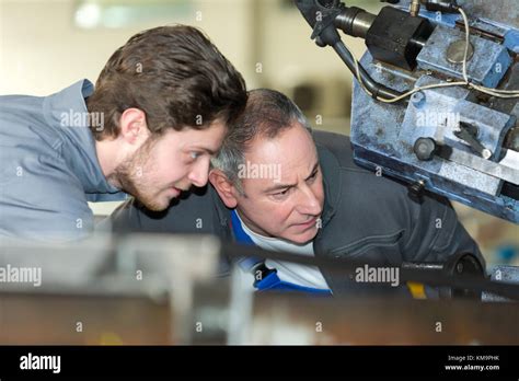 Apprentice Mechanic In Auto Shop Working On Car Engine Stock Photo Alamy