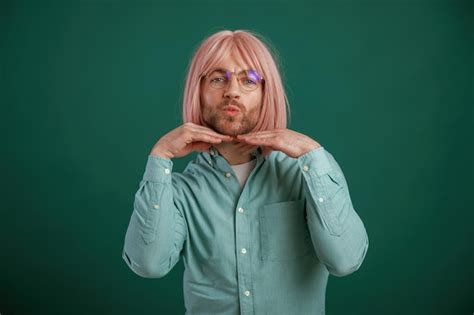 Premium Photo In Glasses Posing Having Fun Gay Man With Pink Hair Is Standing Against Green