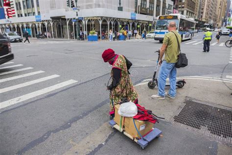 Close Up View Of Homeless Woman With Belongings On Cart Crossing Street