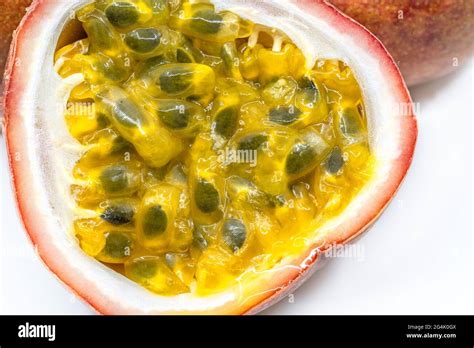 Macro Cut Half Of The Passion Fruit On White Background Show Yellow