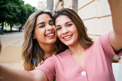 Free Photo | Portrait of two young friends taking a selfie while ...