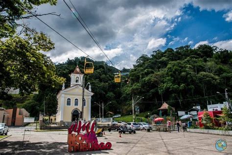 A Small Church In The Middle Of A Town Surrounded By Trees And People