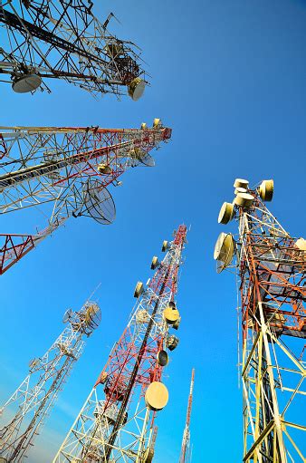 Telecommunications Towers On Blue Sky Antennas For Television Radio And Mobile Phones Stock