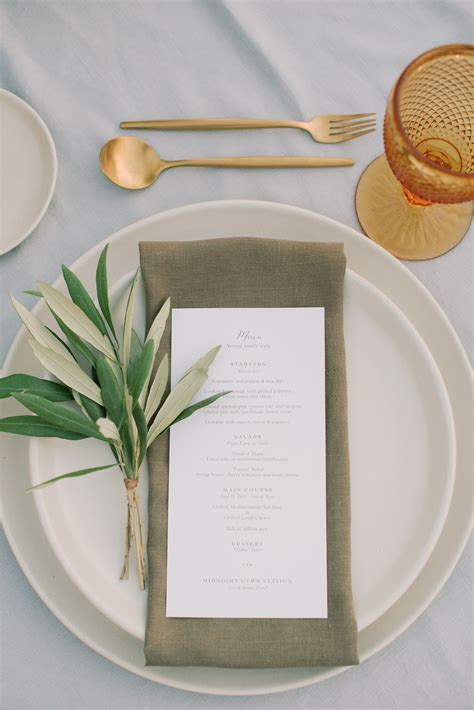 A Table Setting With Place Settings Silverware And Napkins On It Is Shown