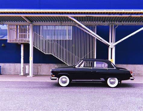 Premium Photo Vintage Car Parked On Road Against Building