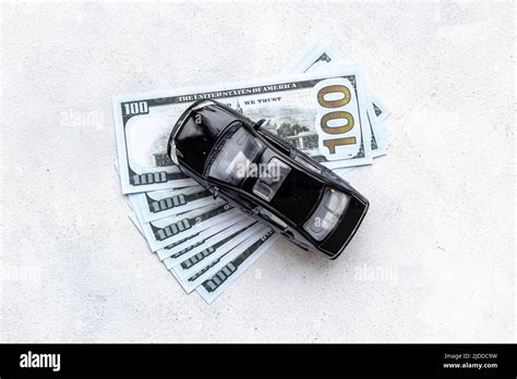 Money to buy or rent a car concept. Toy car with money cash Stock Photo ...